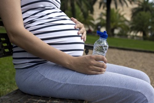 Pregnant woman holding her stomach