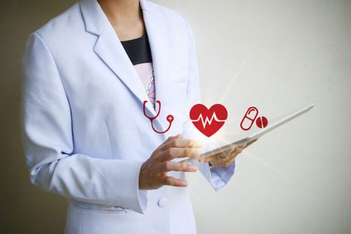 A nurse uses a tablet to set up a telemedicine appointment.