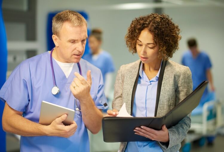 A director of medical services confers with a physician.