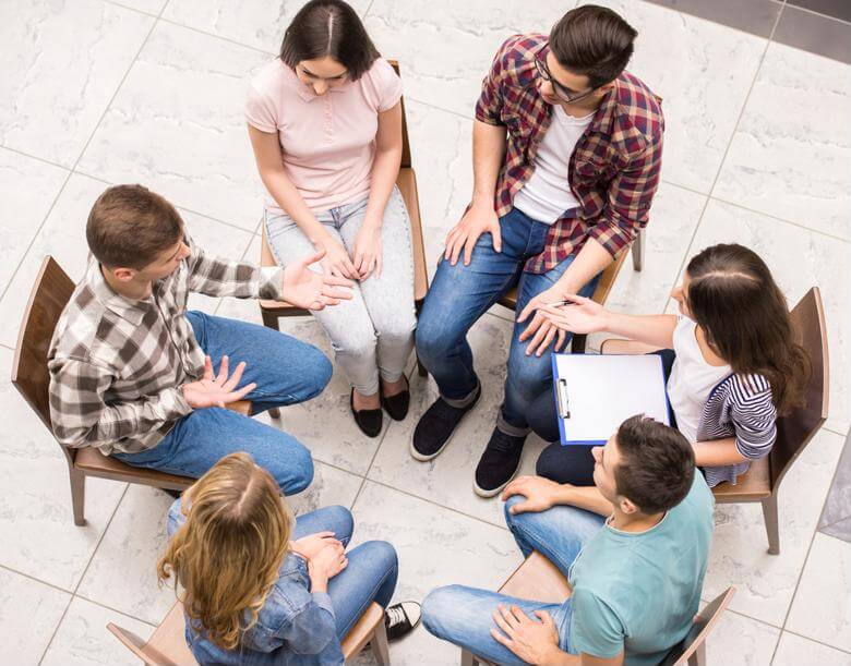 A clinical mental health counselor leads a group therapy session.