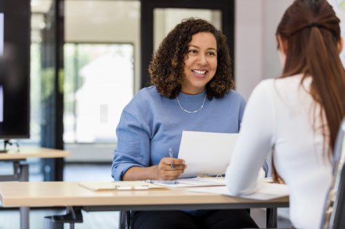 A human resources professional interviews a candidate.