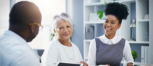 Two women and a man having a discussion