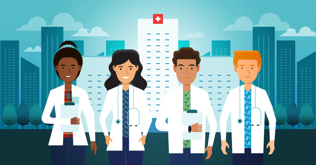 Four smiling nurse practitioners in front of a hospital.