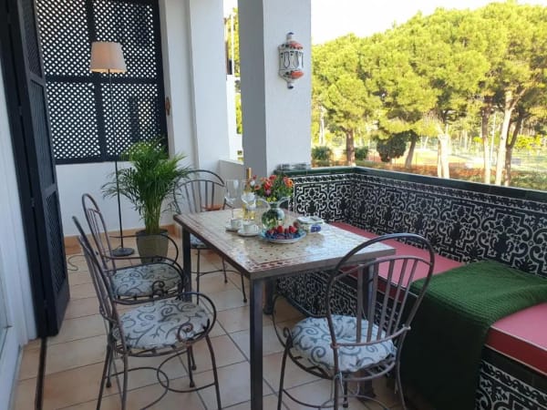 Spacious private terrace with outdoor seating and lush garden views