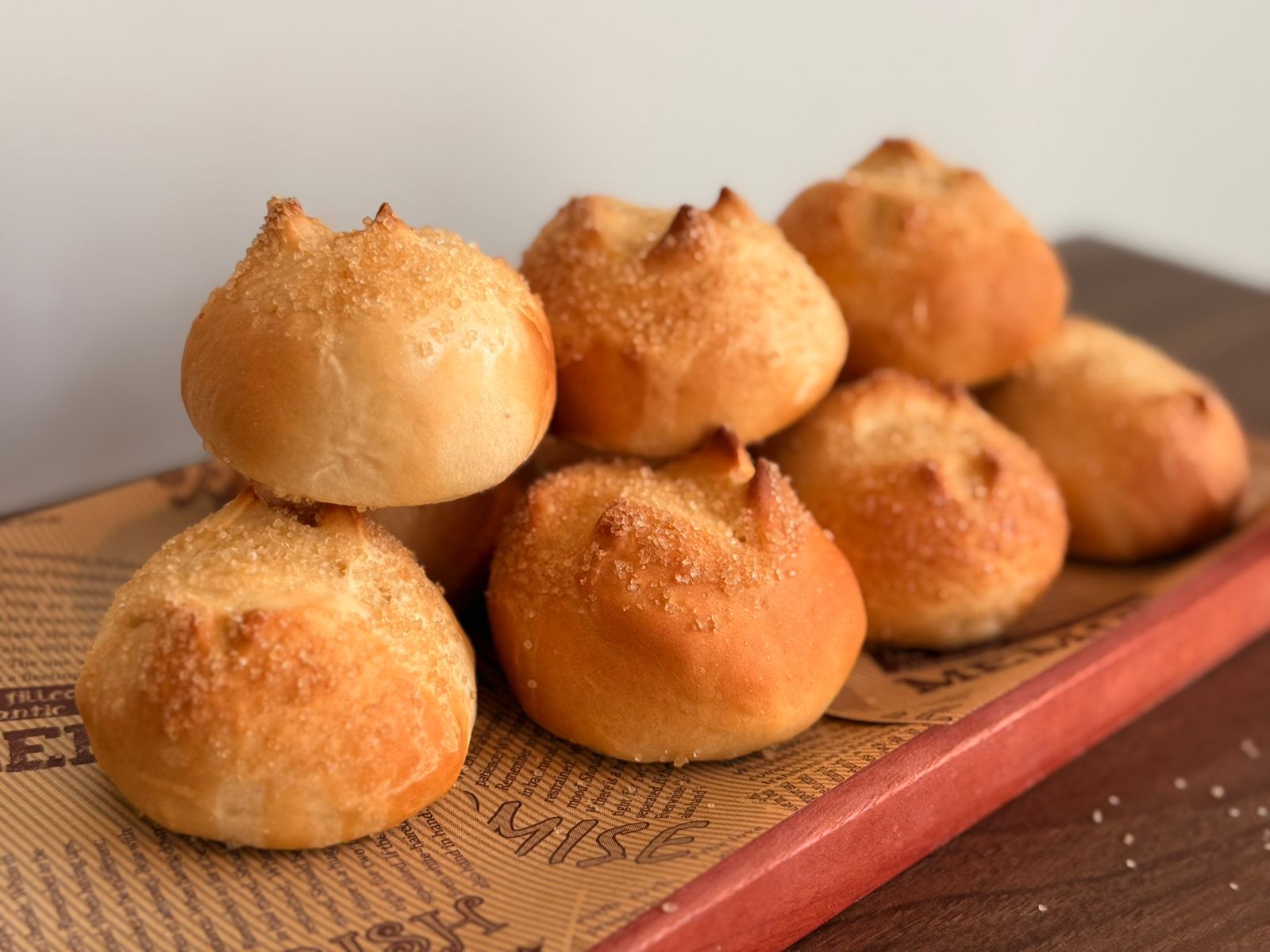 Dense Filipino star-shaped bread rolls dusted with coarse sugar.
