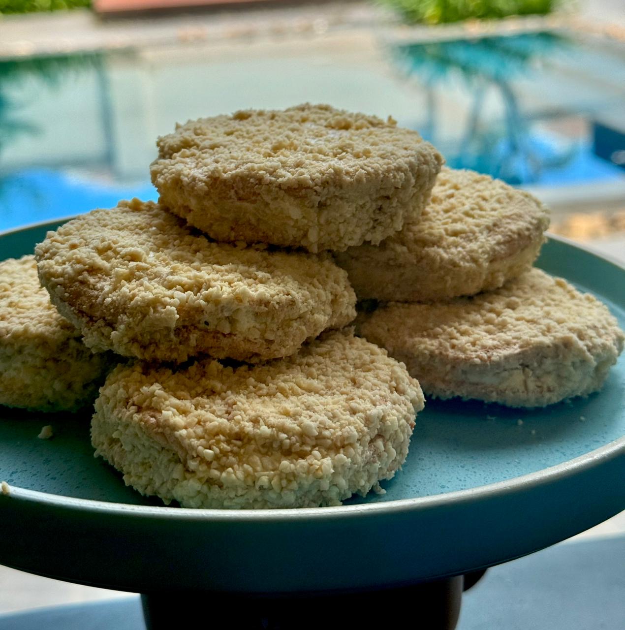 Crispy meringue cookie sandwiches coated in crumbs and filled with buttercream.