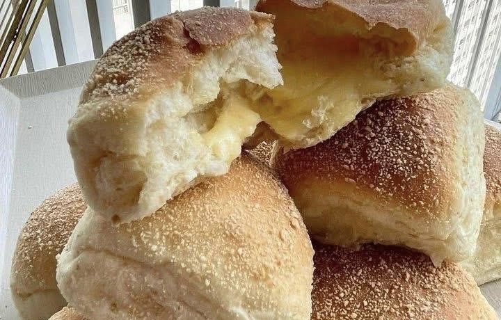Soft Filipino pandesal buns with melty cheese filling.