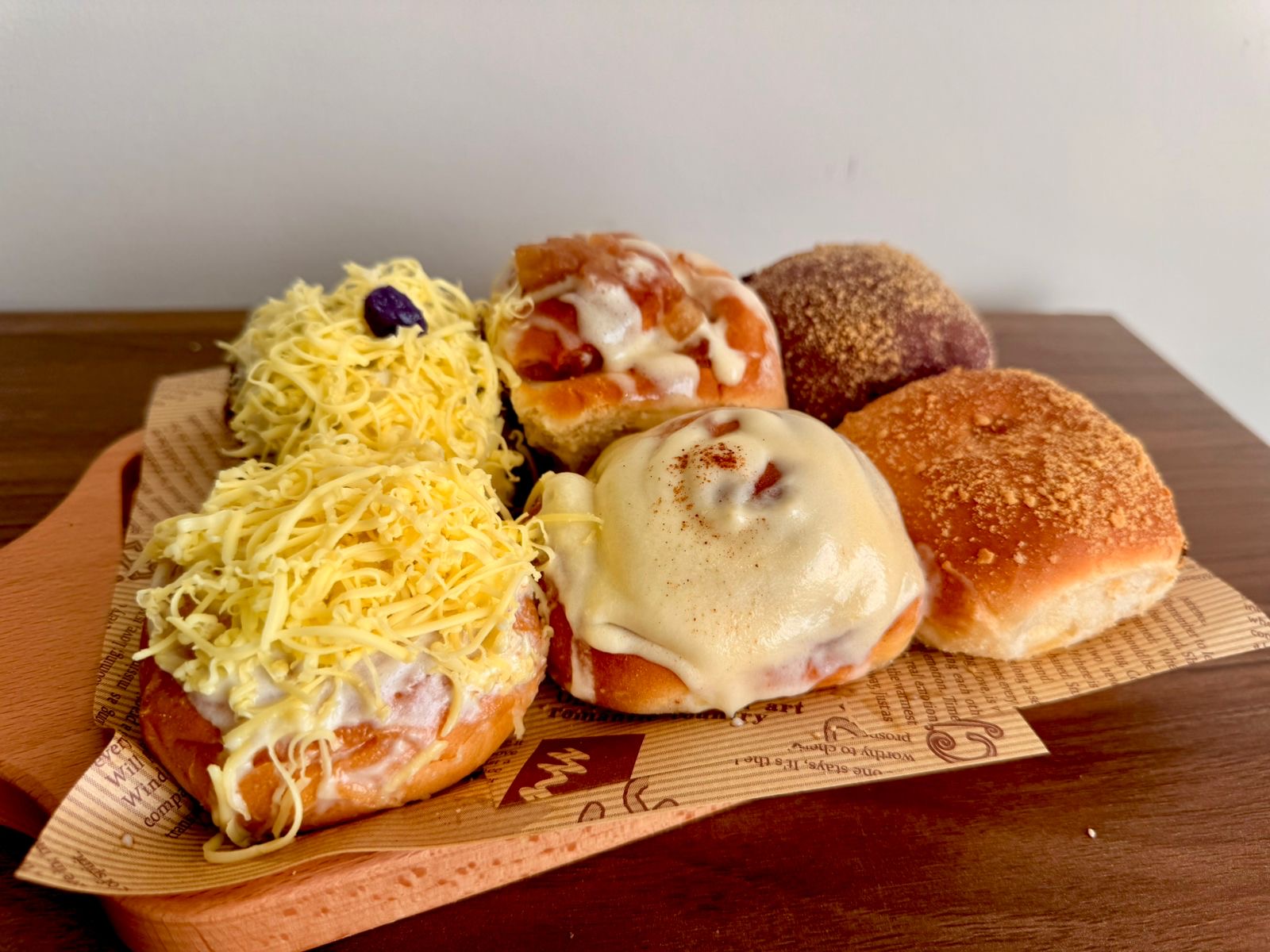 Assorted Filipino bread rolls including ensaymada, pandesal, and cinnamon rolls.