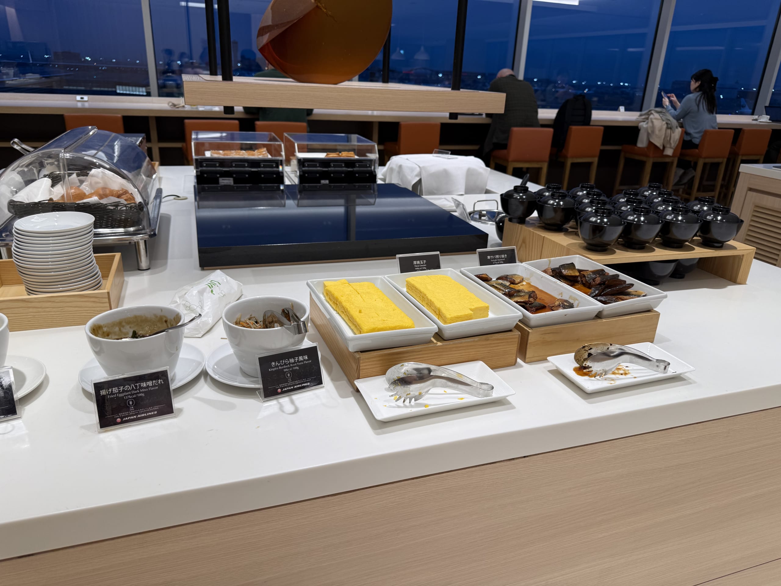 空港ラウンジのビュッフェに並ぶ和食。