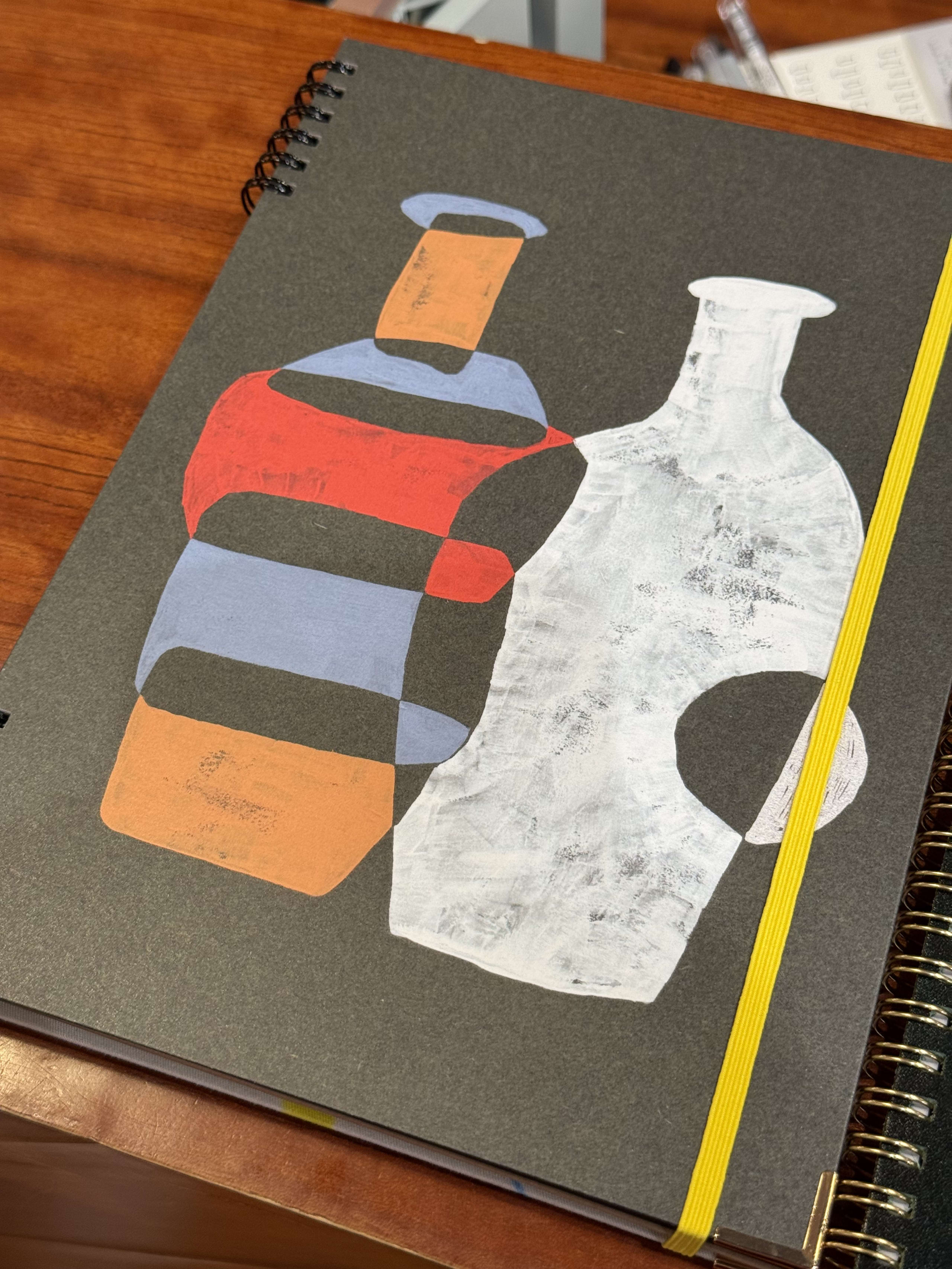黒表紙のノートに描かれたボトルのアクリル画