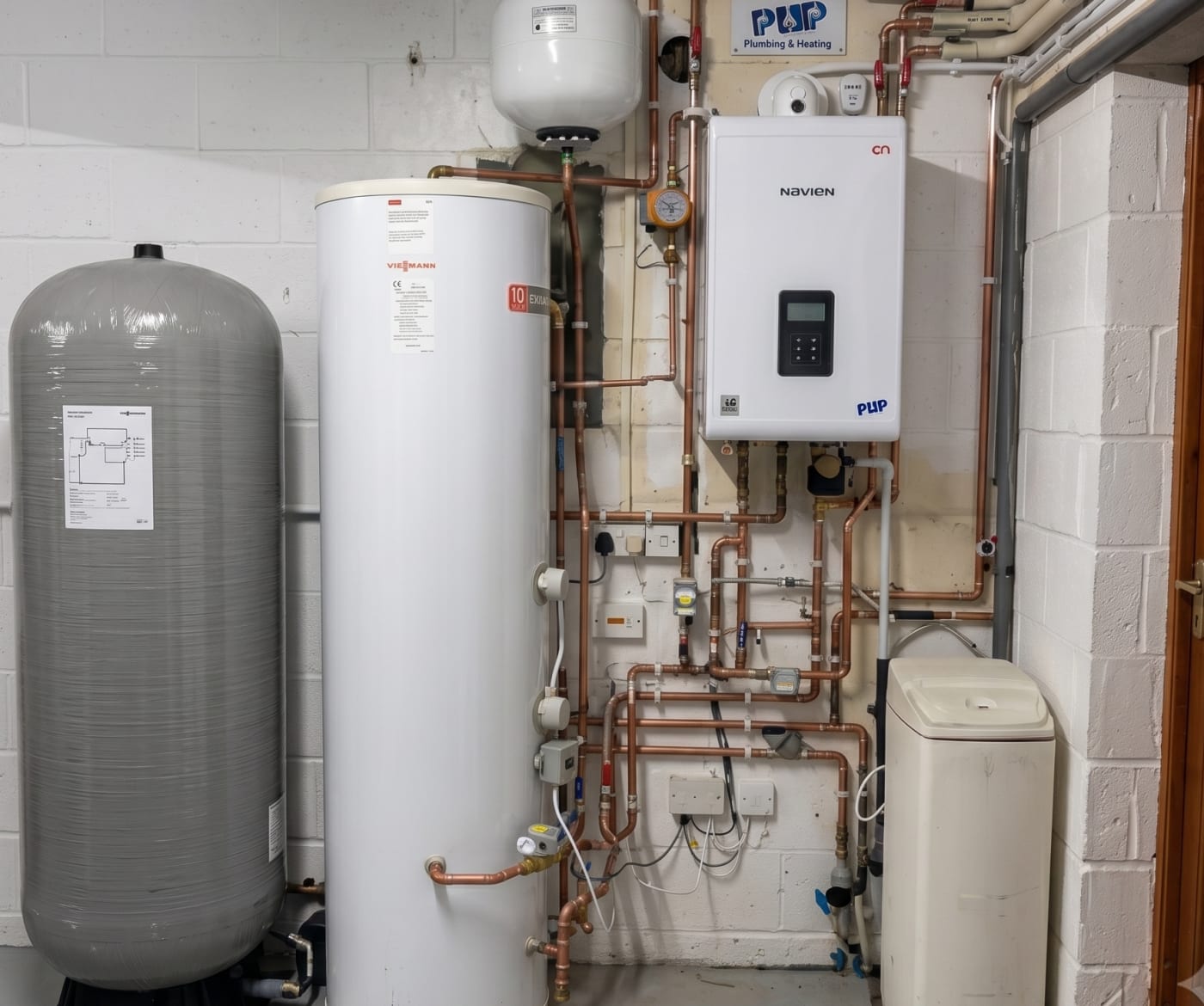 Neat boiler and hot-water cylinder installation with tidy copper pipework by PHP Services