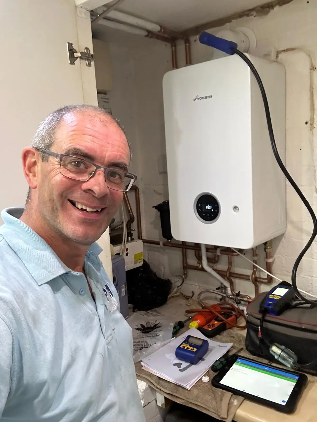 PHP Services engineer completing a boiler installation in St Albans