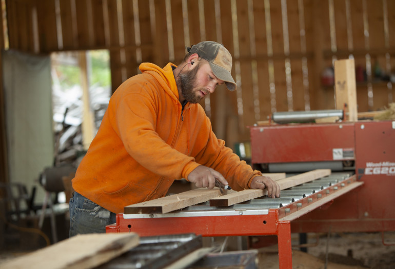 Luke using Wood-Mizer EG200 board edger