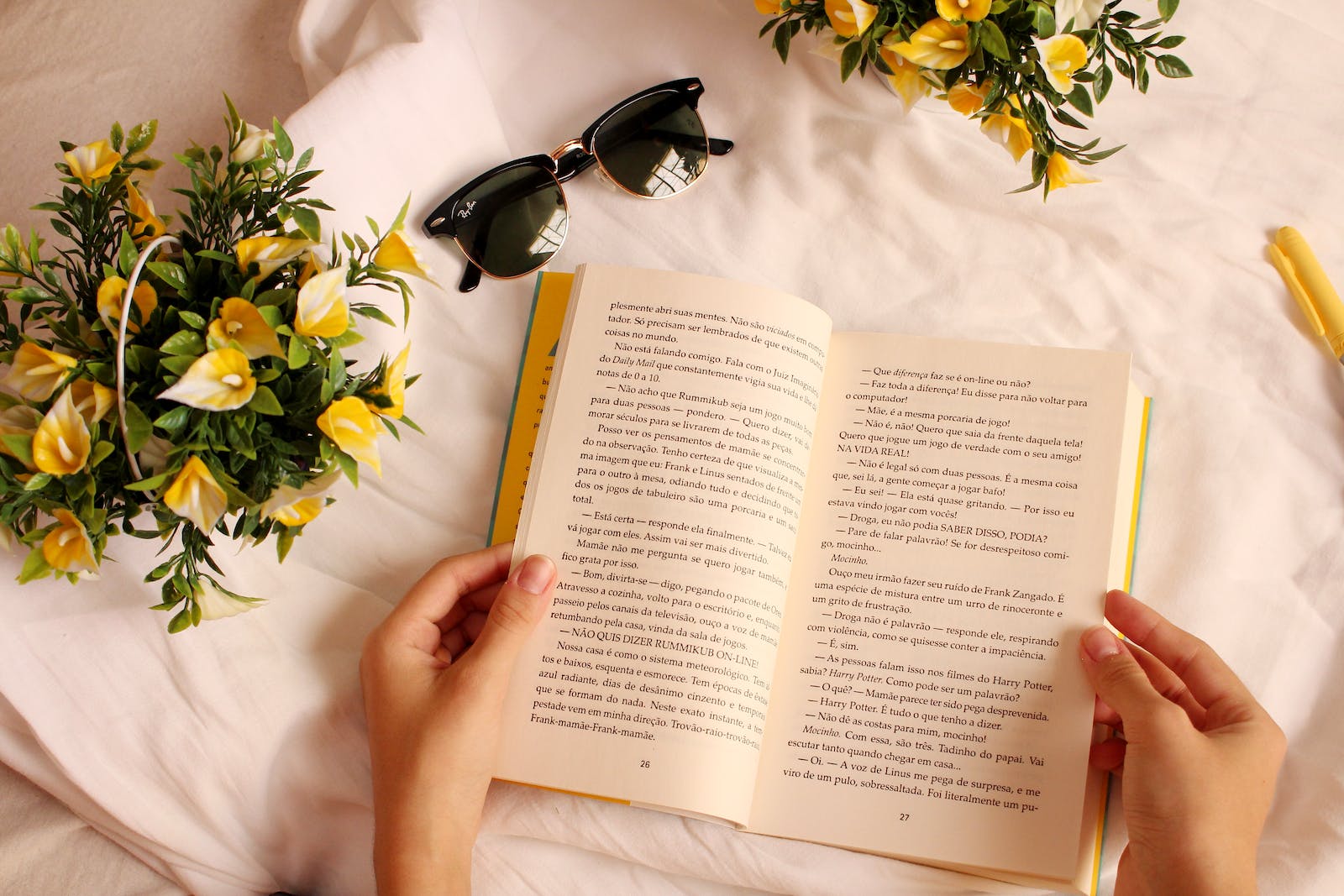 Reading a book surrounded by yellow flowers 