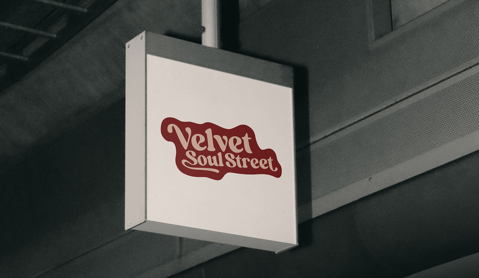 A neon sign of the band Velvet Soul Street can be seen in the public space.