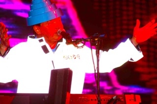 Devo frontman performing at Heaven Gala with iconic flowerpot hat