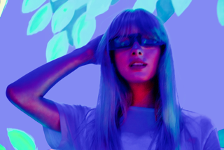 Portrait — woman with sunglasses in blue and purple neon light