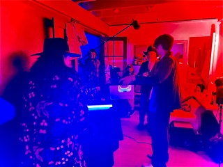 On set with red and blue neon lighting — production still