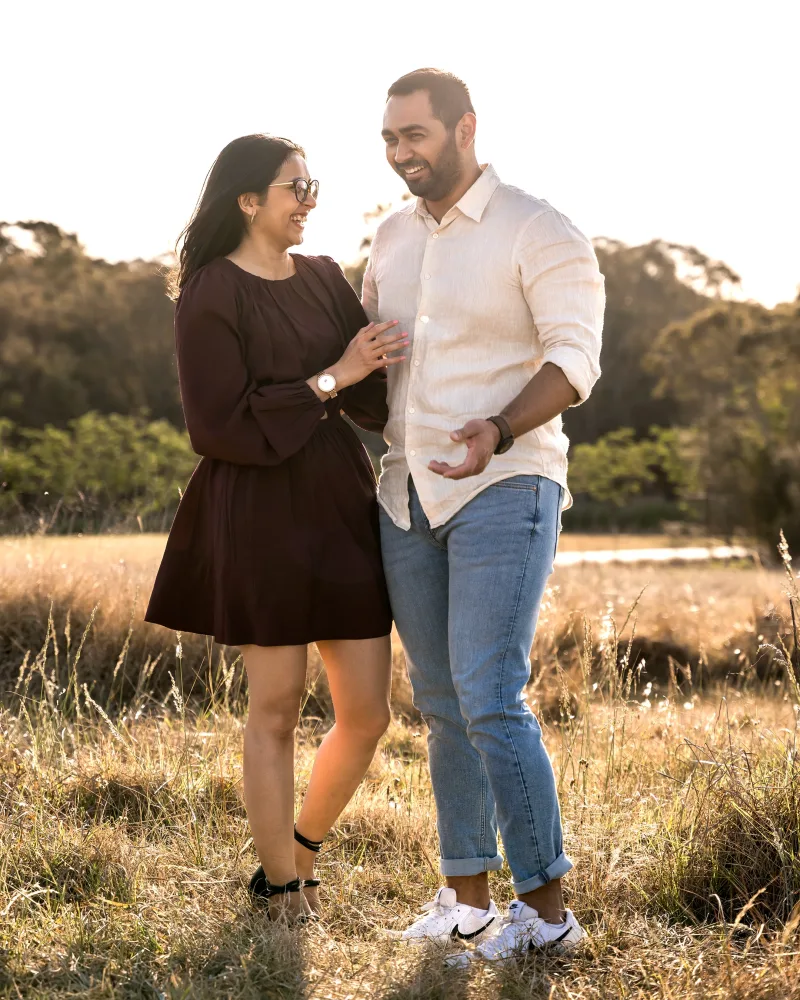 Newly engaged couple laughing together at Rouse Hill Regional Park