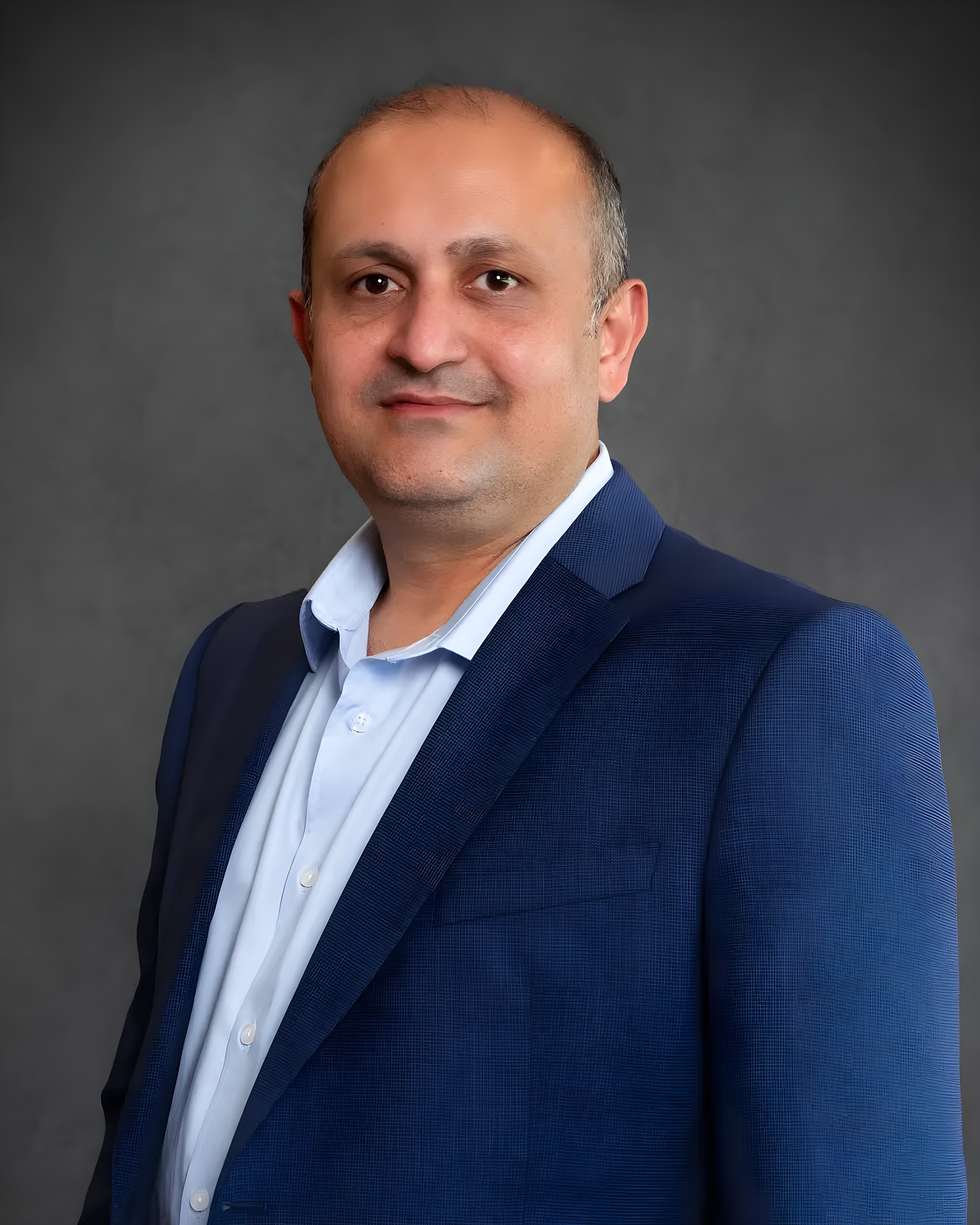 Professional corporate headshot of a man wearing a blue blazer, photographed in Sydney