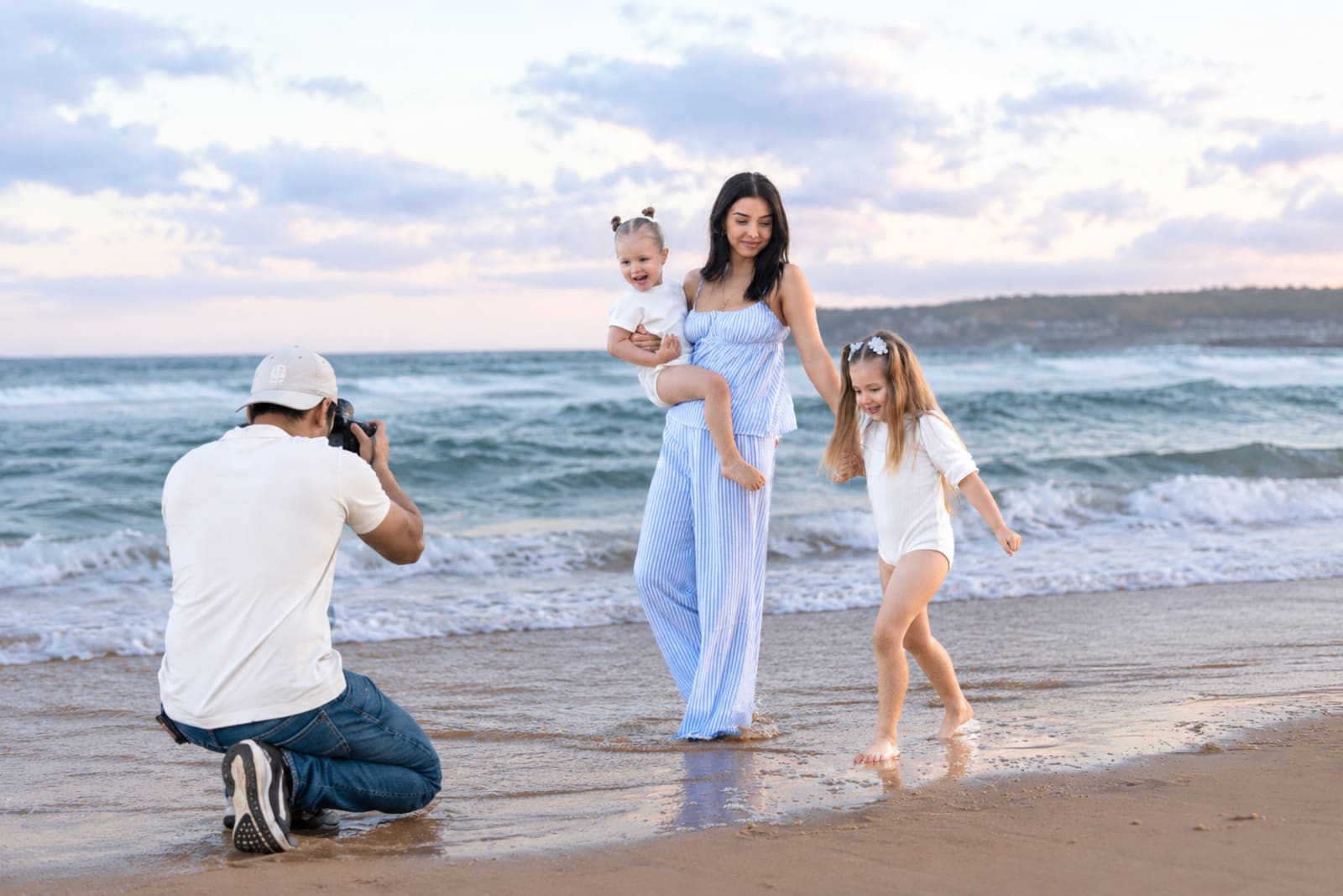 Shekhar Jay photographing a mother with her two young daughters on the beach at sunset, Hills District family photographer
