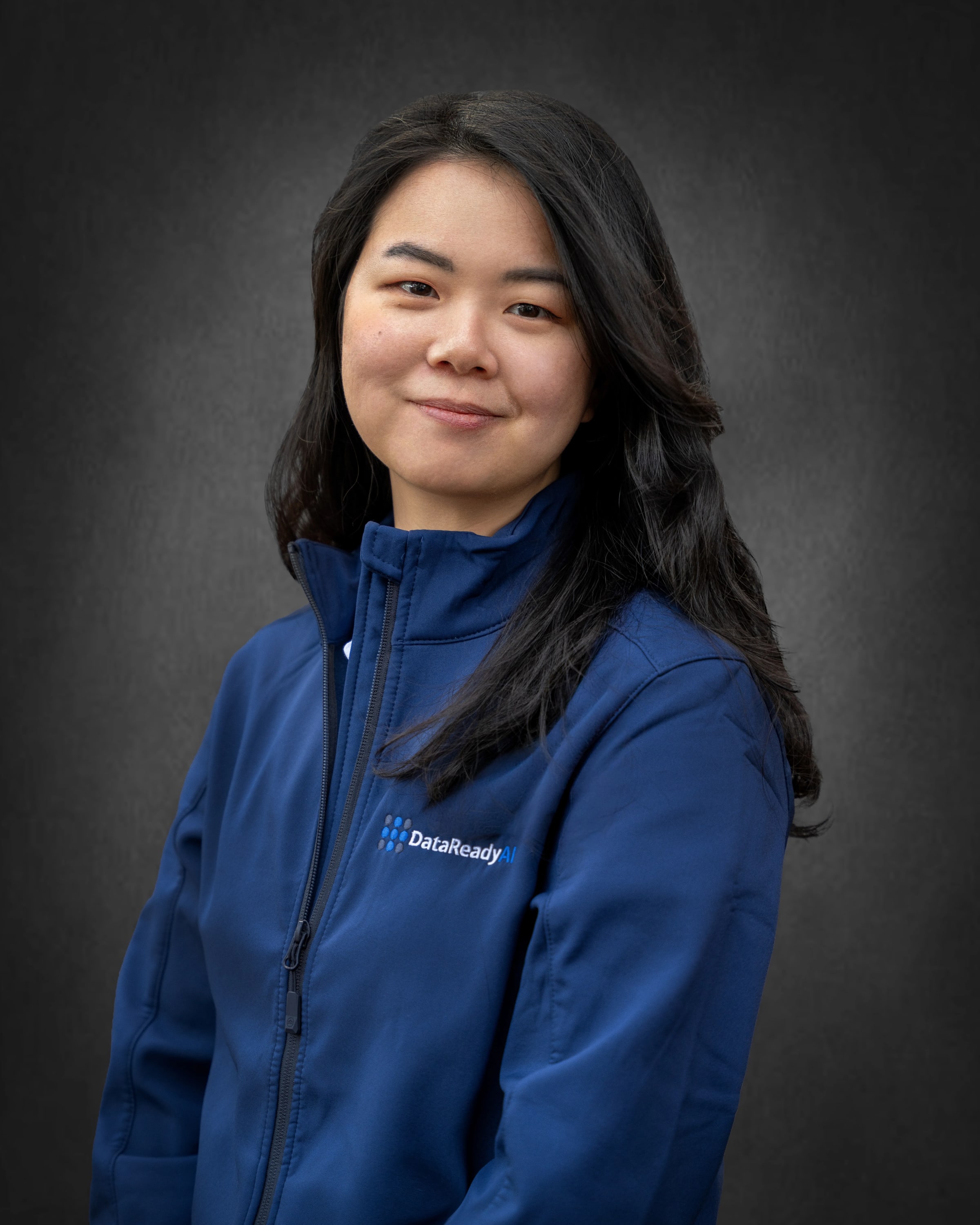 Corporate headshot of a woman in a navy company jacket, photographed in Sydney