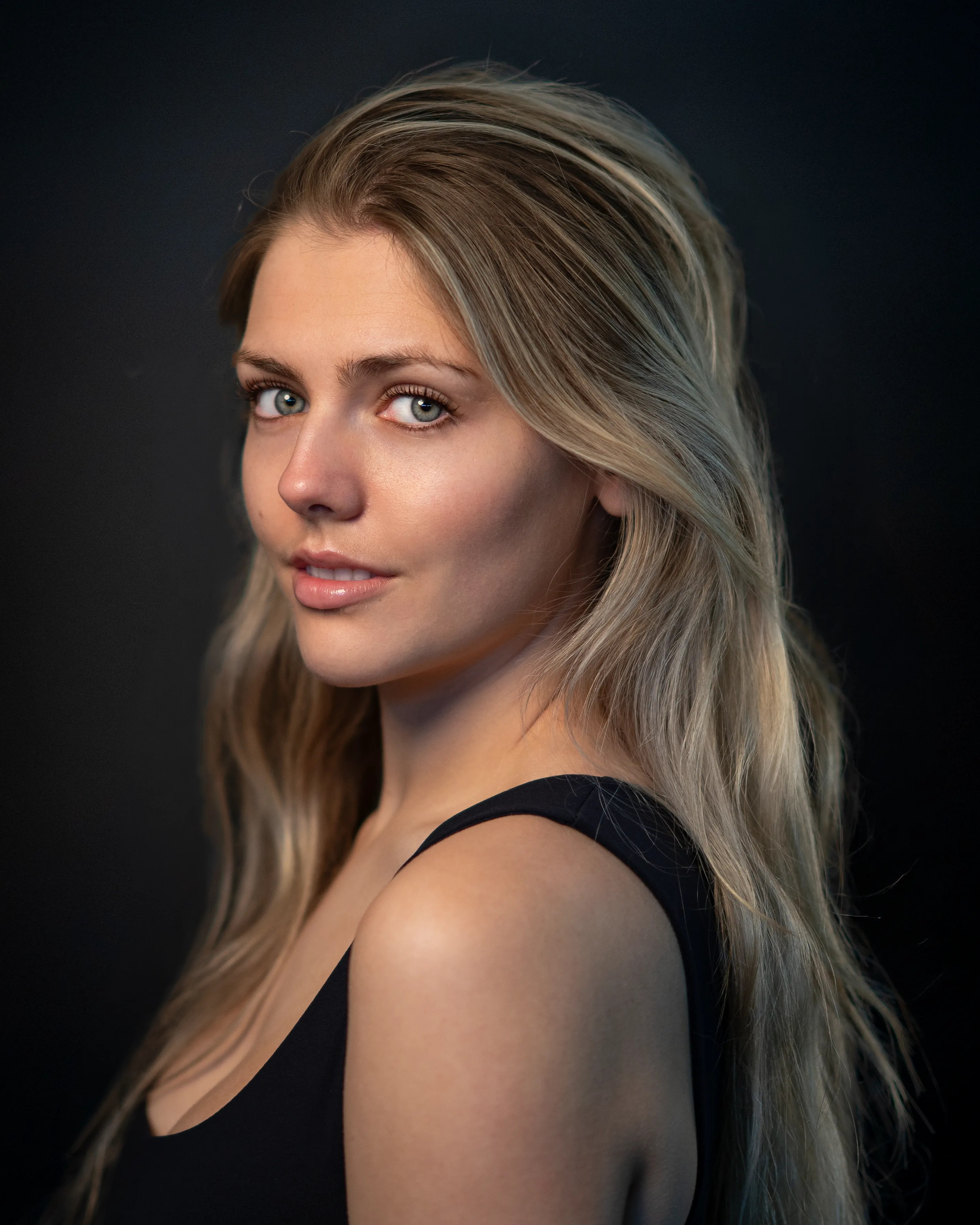 Editorial-style corporate portrait of a woman with dramatic lighting