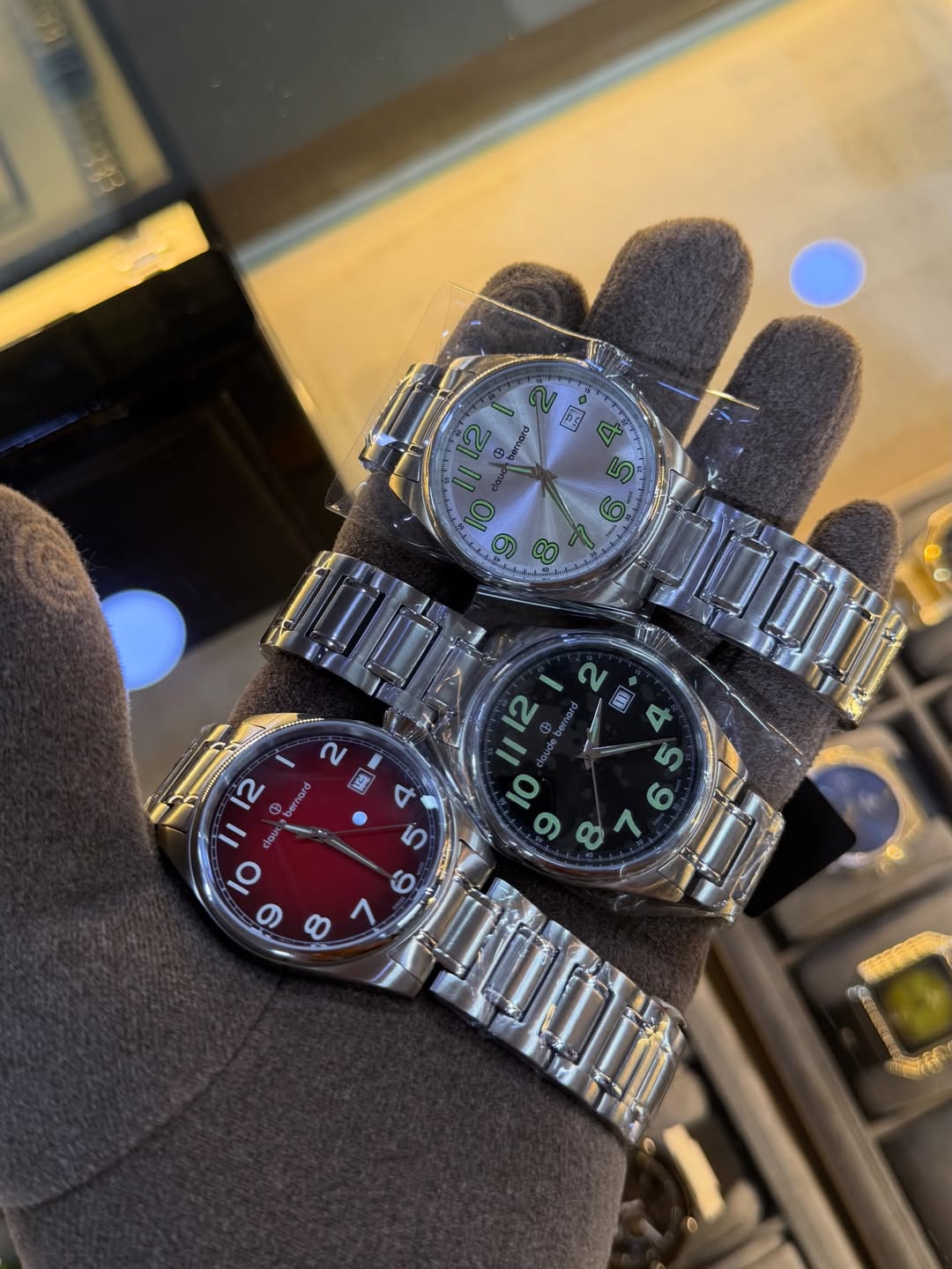 Claude Bernard watches held in a gloved hand at The Deluxe Place