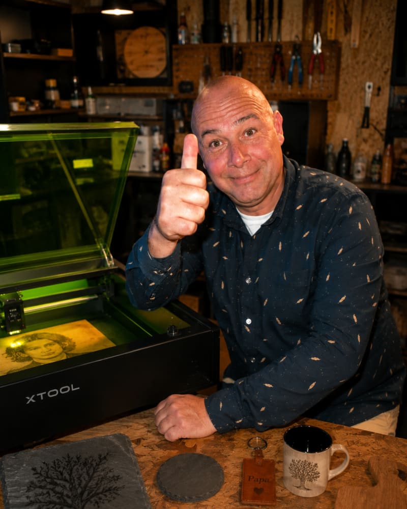 Thierry Veaud dans son atelier de Montagne, devant sa machine de gravure laser et ses créations — Créa Laser Bois