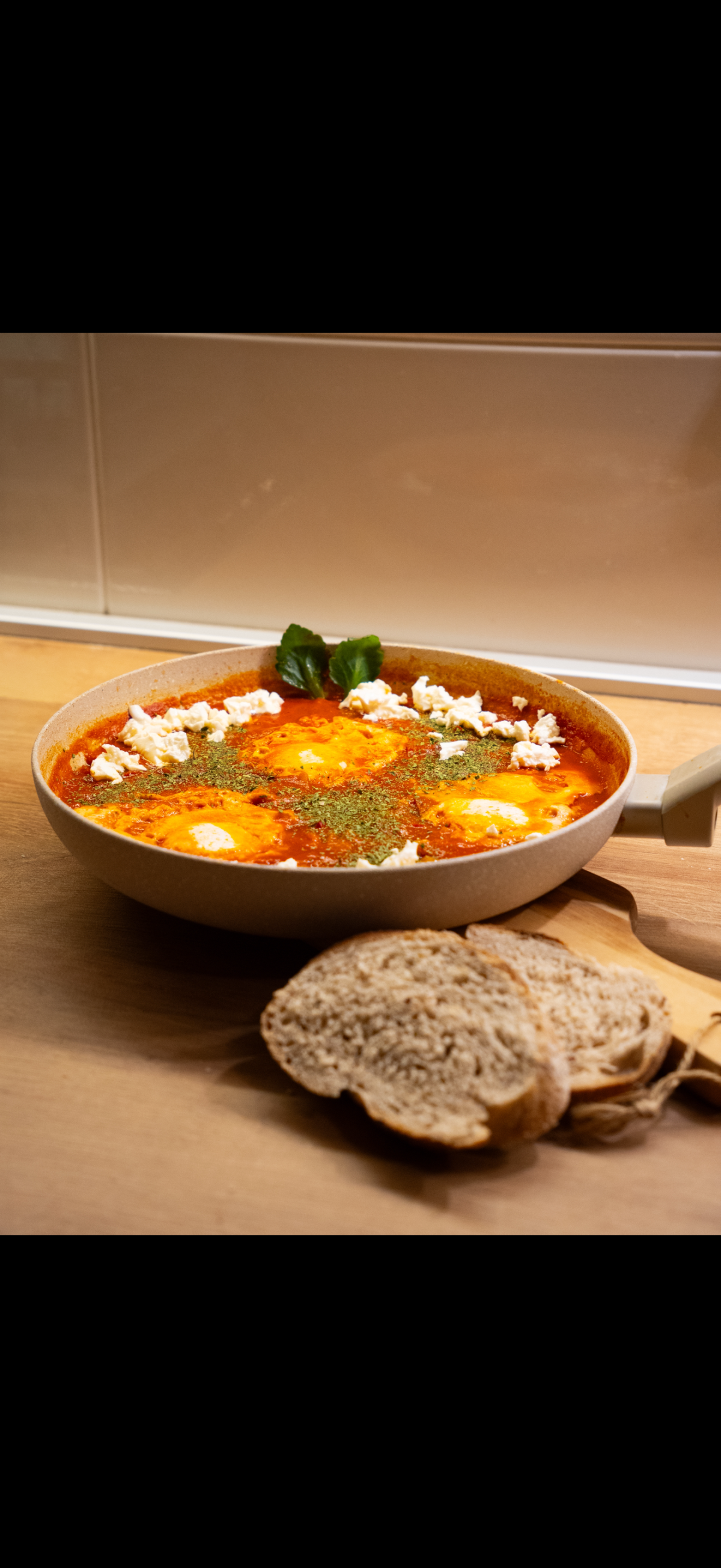 Traditional shakshuka with feta and crusty bread