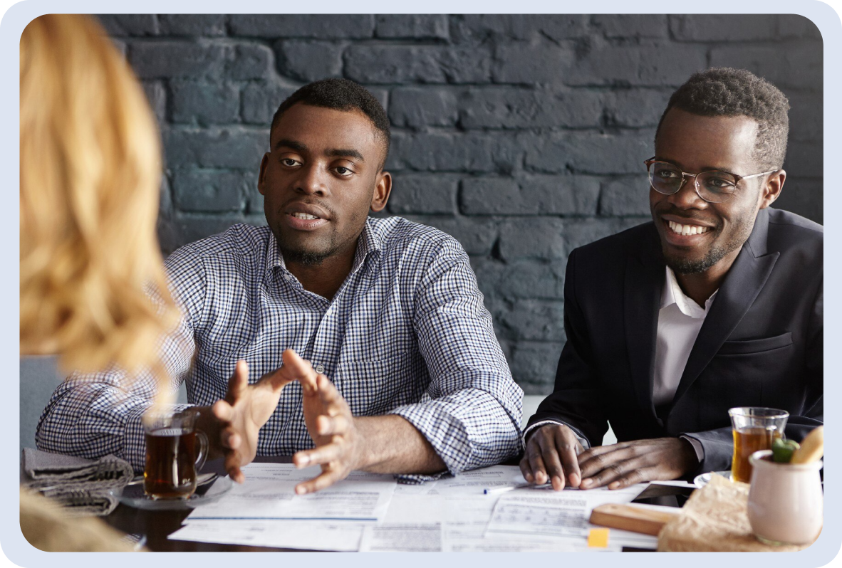 Image of 2 guys talking buisness with a lady