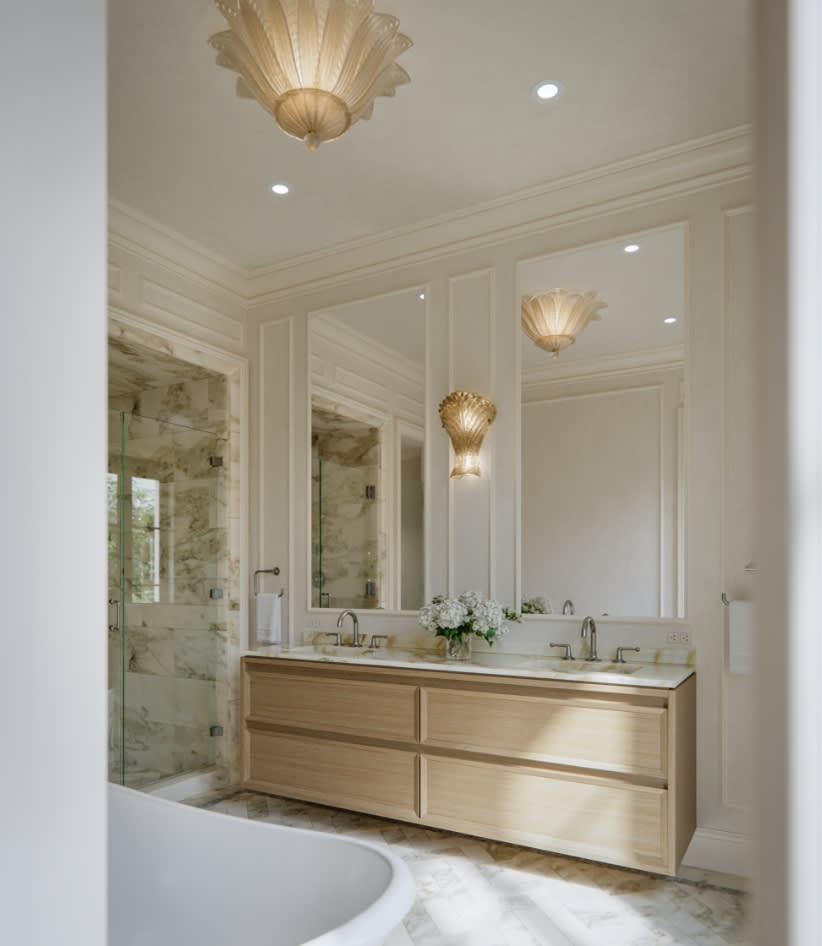 Primary bathroom at The George with honed marble surfaces, custom vanity cabinetry, and refined hardware bringing spa-like calm to every detail