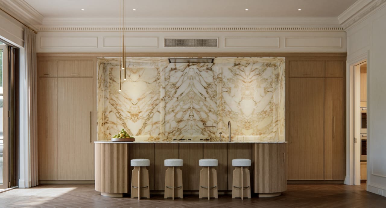 Main kitchen at The George featuring a dramatic dark island with stone waterfall countertop, statement hood, and custom cabinetry in warm natural tones