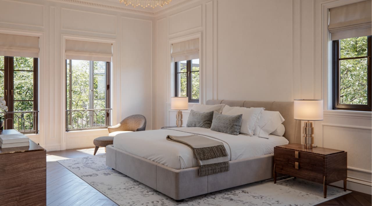 Primary bedroom at The George with soft linen bedding, floor-to-ceiling windows, and warm natural light washing over pale stone floors