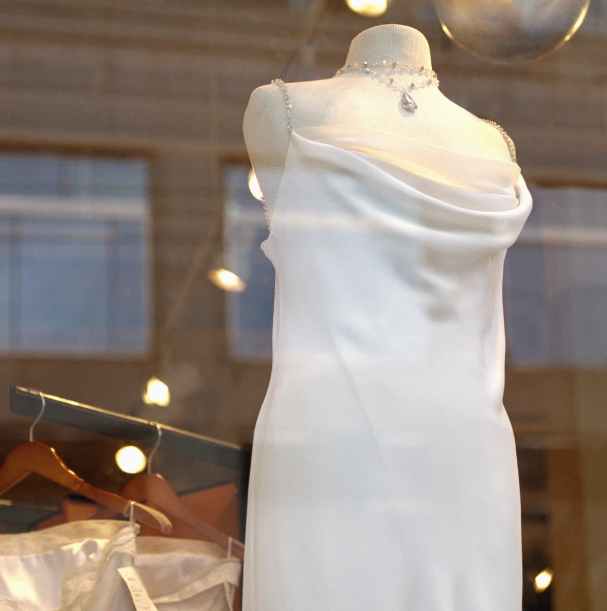 A couture white gown displayed in the window of a Coral Gables boutique, reflecting the neighborhood’s refined shopping culture