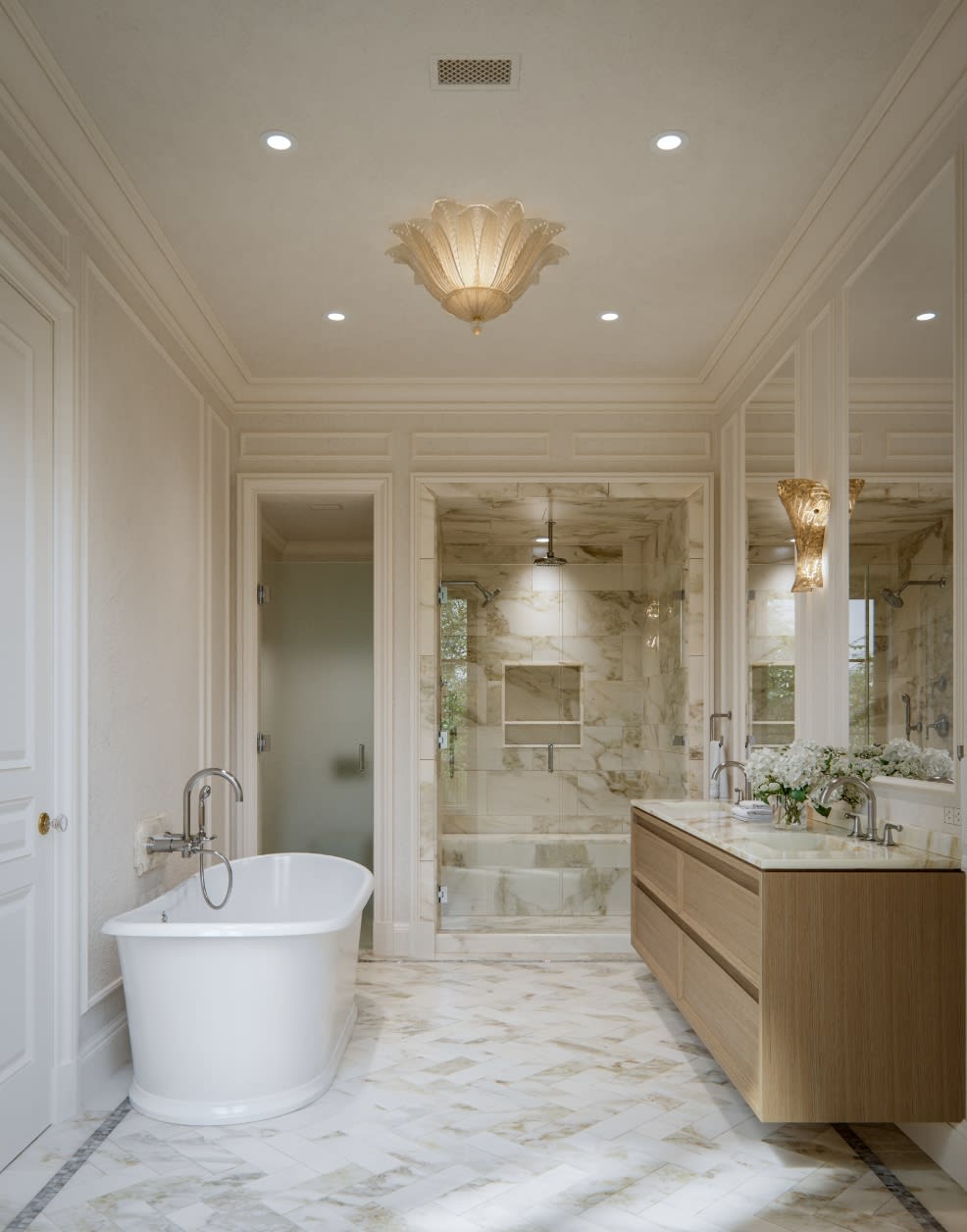 Primary bathroom with freestanding tub, natural stone floors, and Waterworks fixtures