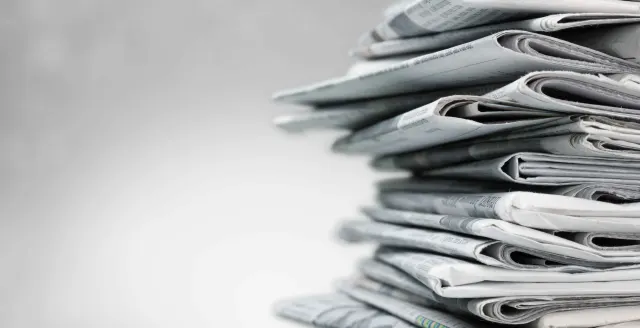 Stacked newspapers representing industry insight and logistics news