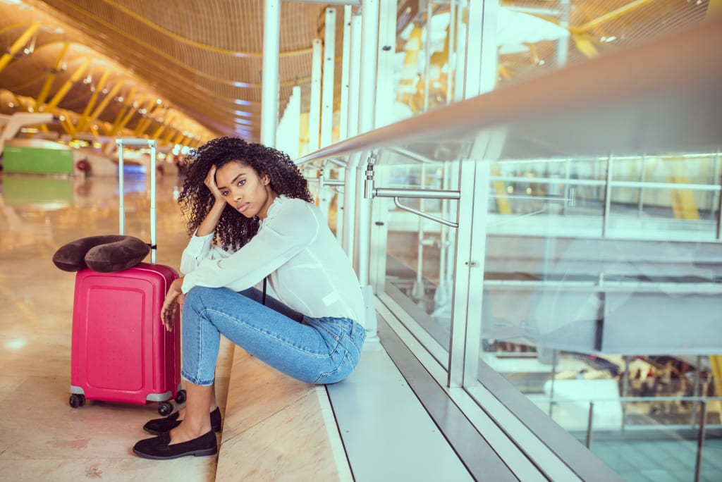 woman suffering with jet lag at airport