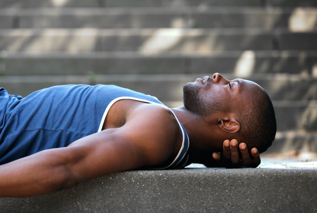 Side portrait of a man sleeping outside