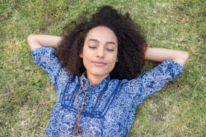 Young woman napping in park