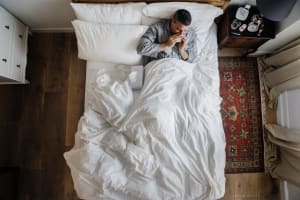 man with lack of sleep on the bed