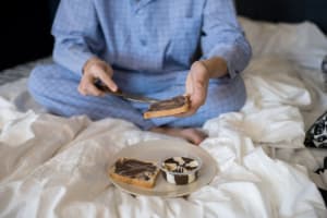 Man in pajamas having breakfast in bed