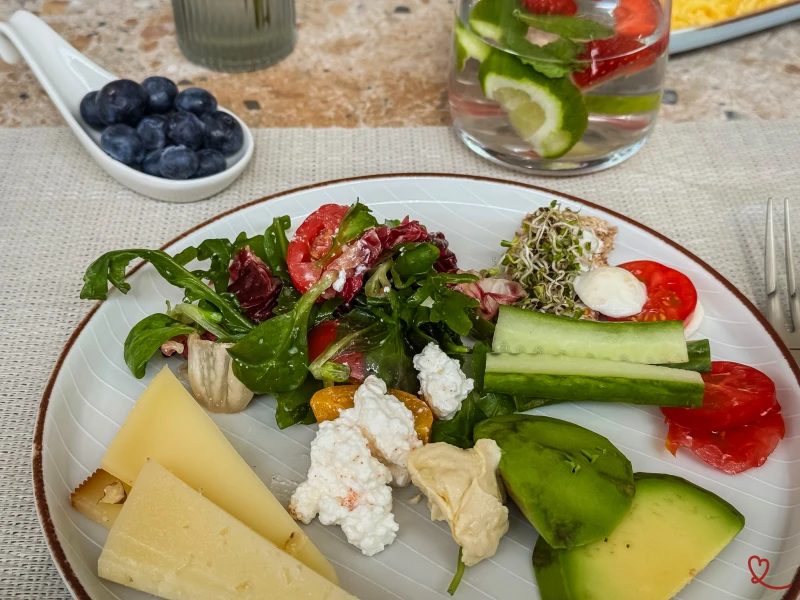 Assiette de salades, fromages, légumes frais et fruits.