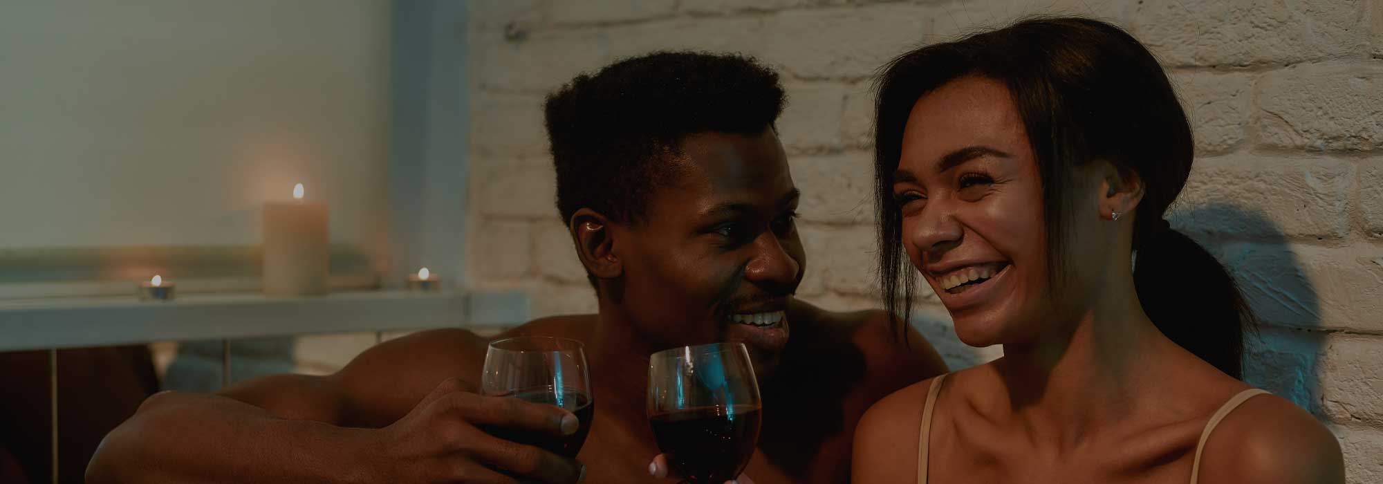 Couple in the bath with red wine