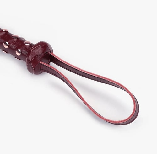 Red Leather Studded Flogger closeup of the handle strap