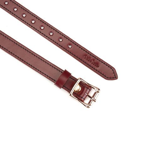 Close up of the red wine leather blindfold buckle and strap