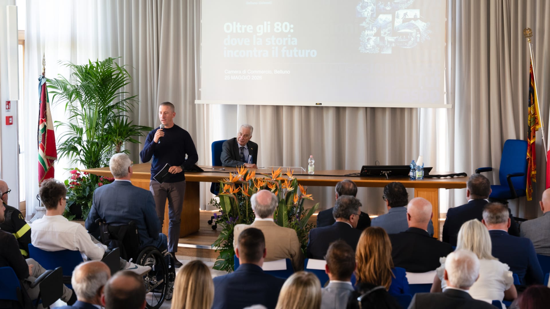 Evento «Oltre gli 80: dove la storia incontra il futuro» alla Camera di Commercio di Belluno, con relatori e platea