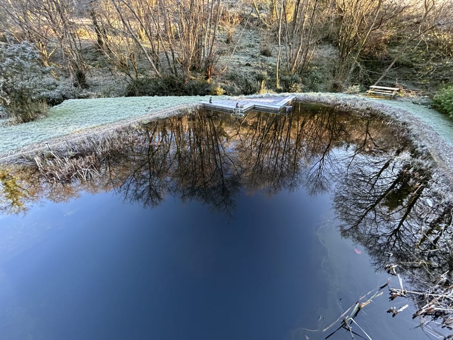 Cedar wood-fired hot tub with logs at Hole Mill holiday cottage, Devon winter