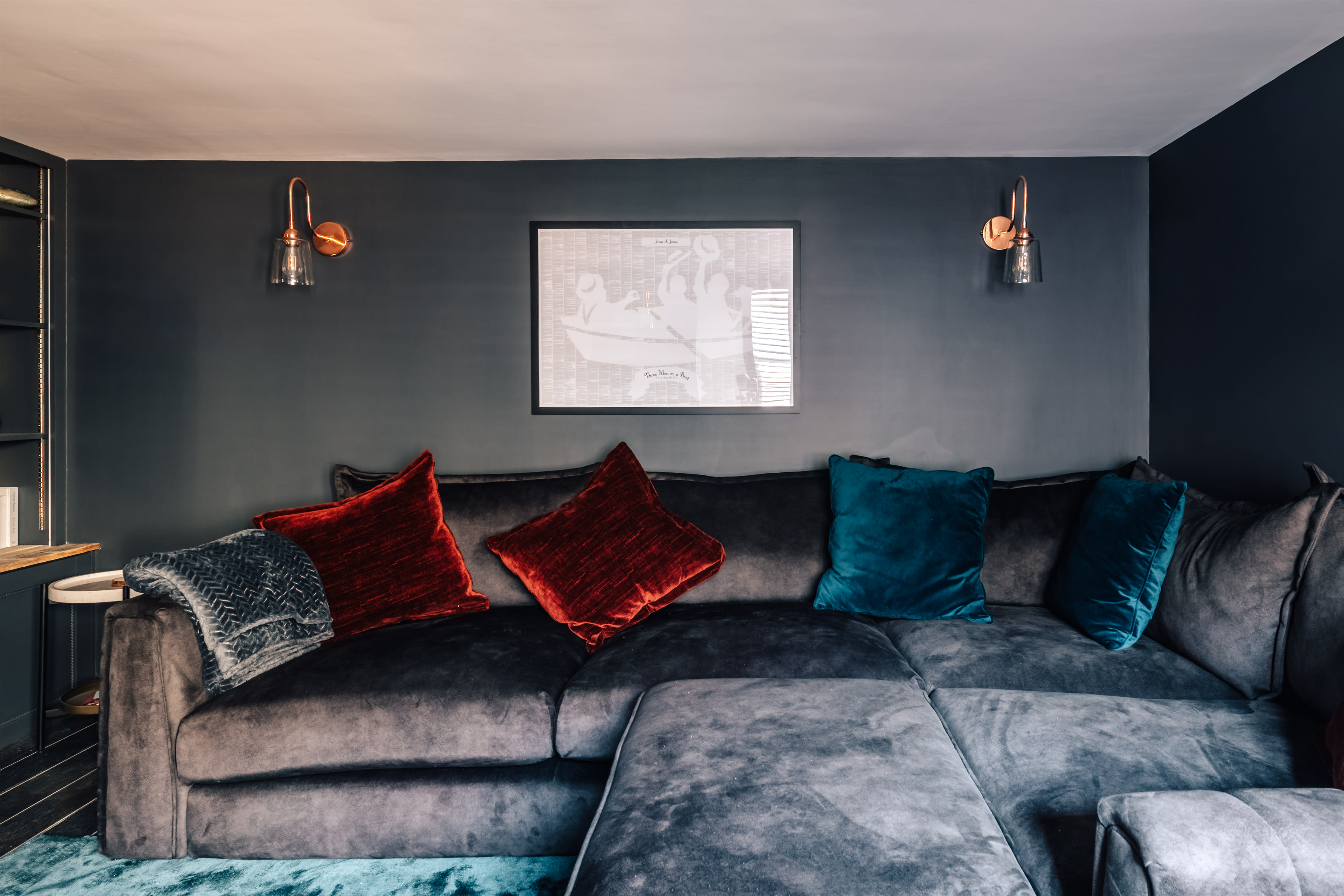 The snug with a voluminous sofa and games cupboard at Weir House, Sonning