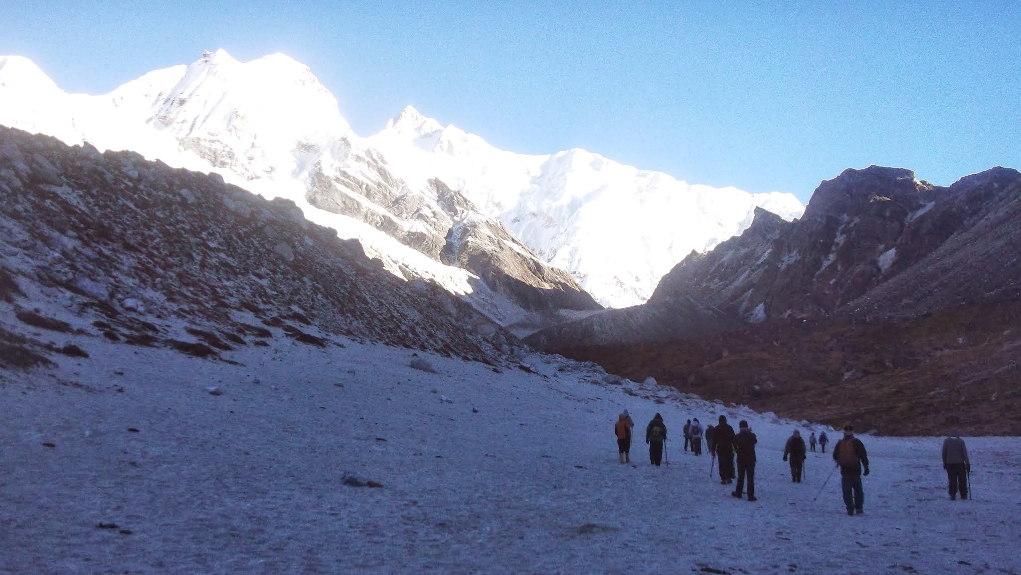 Trekkers approaching the high Himalayas on the Goechala Trek with Kanchenjunga and Pandim in the background
